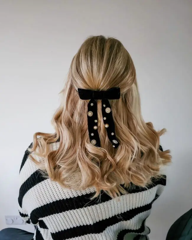 Half-Up Hairstyle with Velvet Bow Embellishment