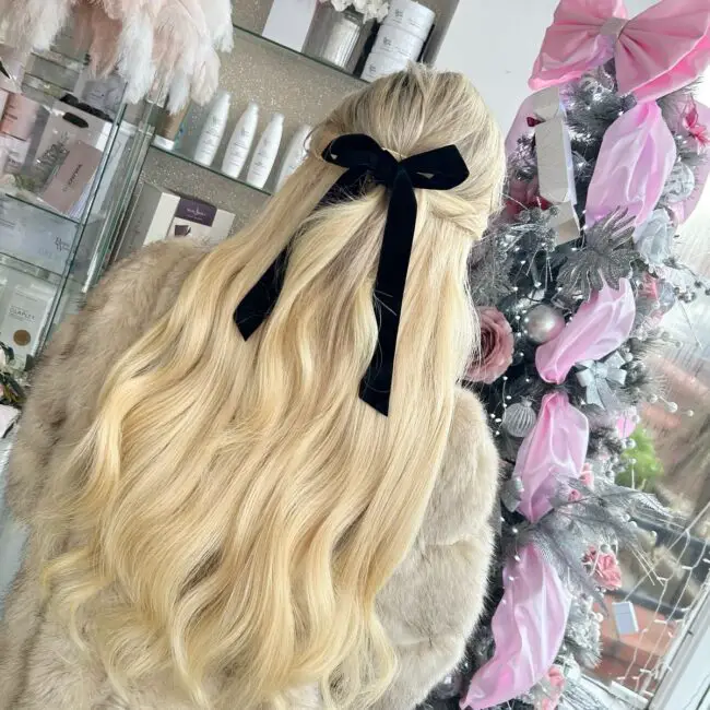 Voluminous Half-Updo with a Velvet Bow
