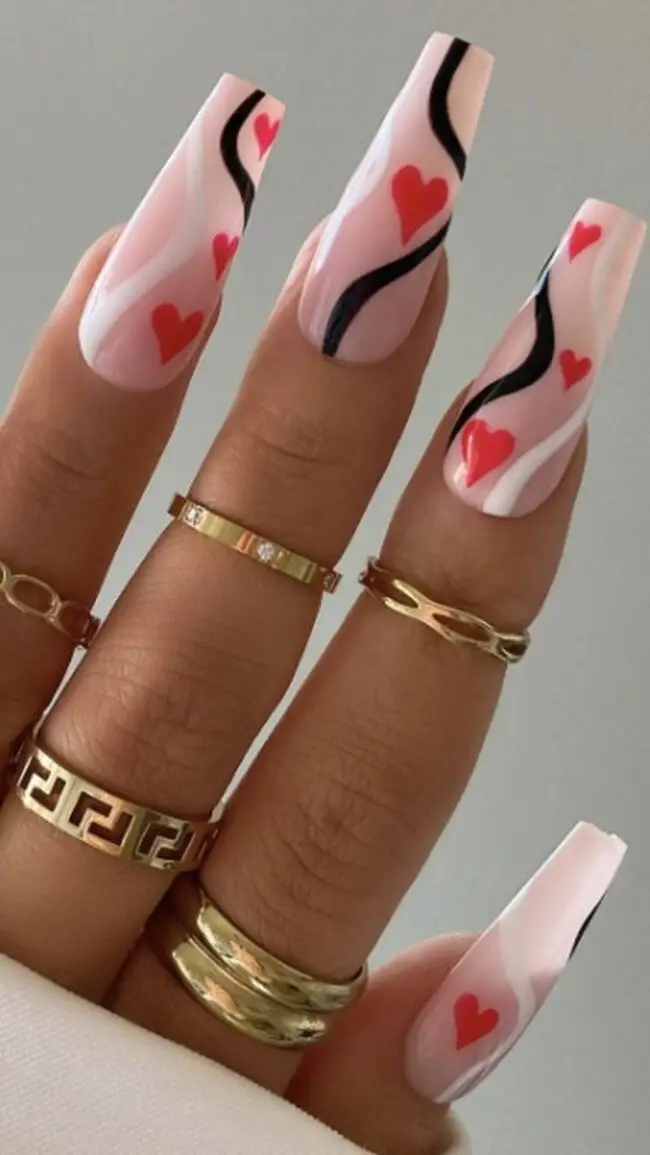 Elegant Red Almond Nails with Heart Detail